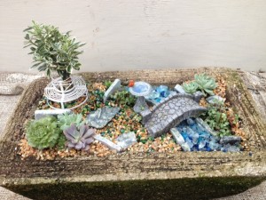 Miniature garden w/ var. euonymous std, stone bridge, b/bath w/ cardinal